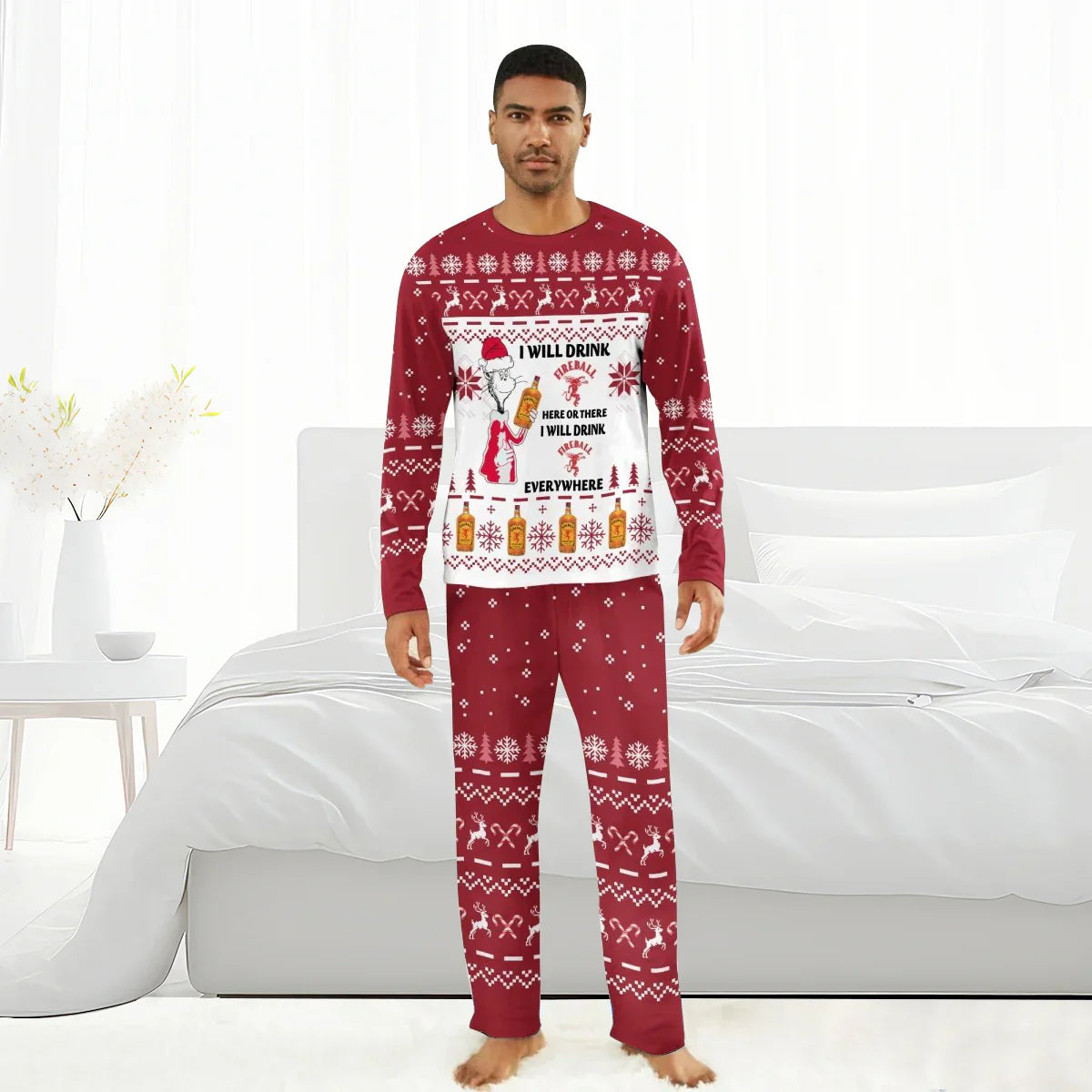 Man wearing red and white Christmas pajamas with Fireball whiskey bottles and holiday patterns in a bright bedroom