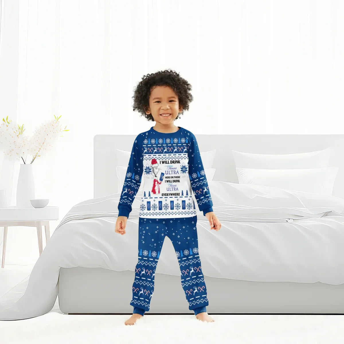 Child wearing blue and white Christmas pajamas with festive patterns standing in a bright bedroom