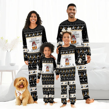 Family of four wearing matching black Christmas pajamas with reindeer, trees, and 'Full of Christmas Spirit' text, dog included