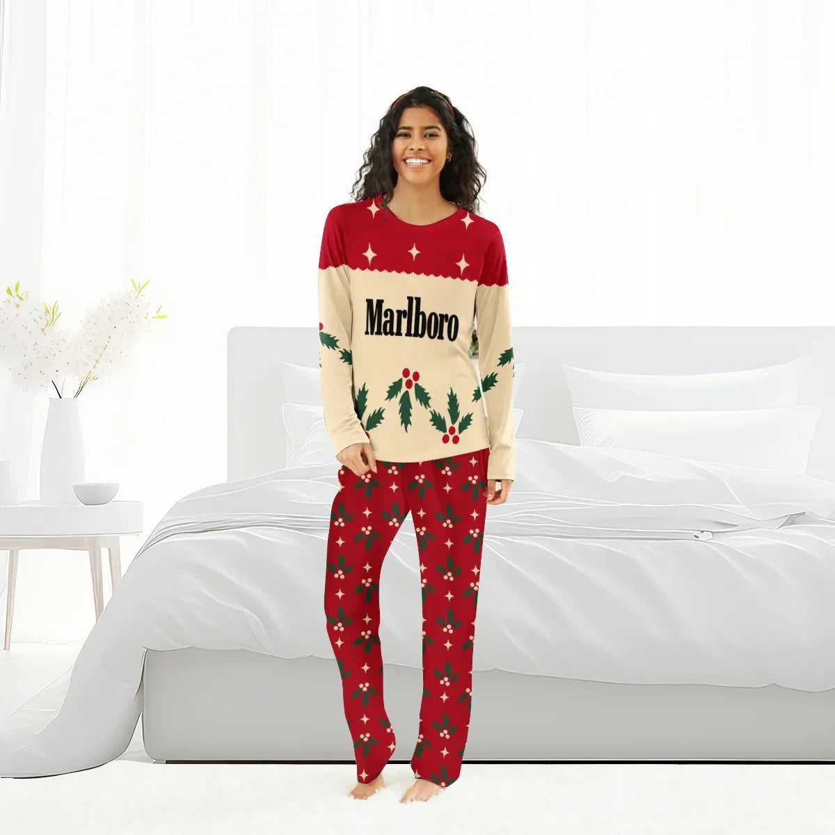 Smiling woman in Marlboro Christmas cherry pajama set standing barefoot in bright modern bedroom