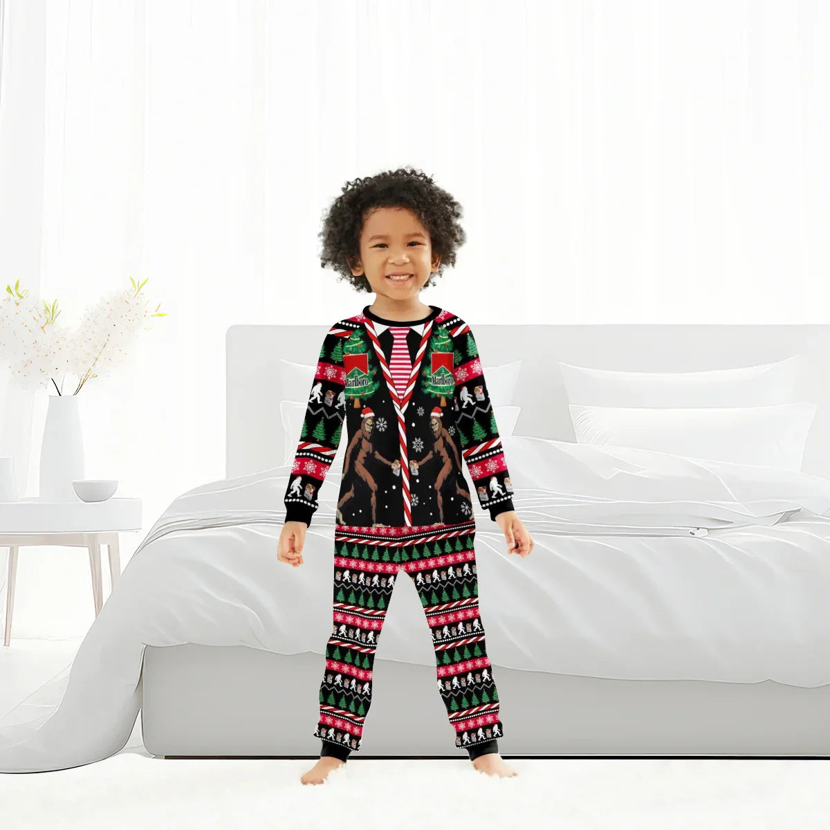 Child in festive Marlboro Bigfoot Christmas pajamas standing in bright modern bedroom