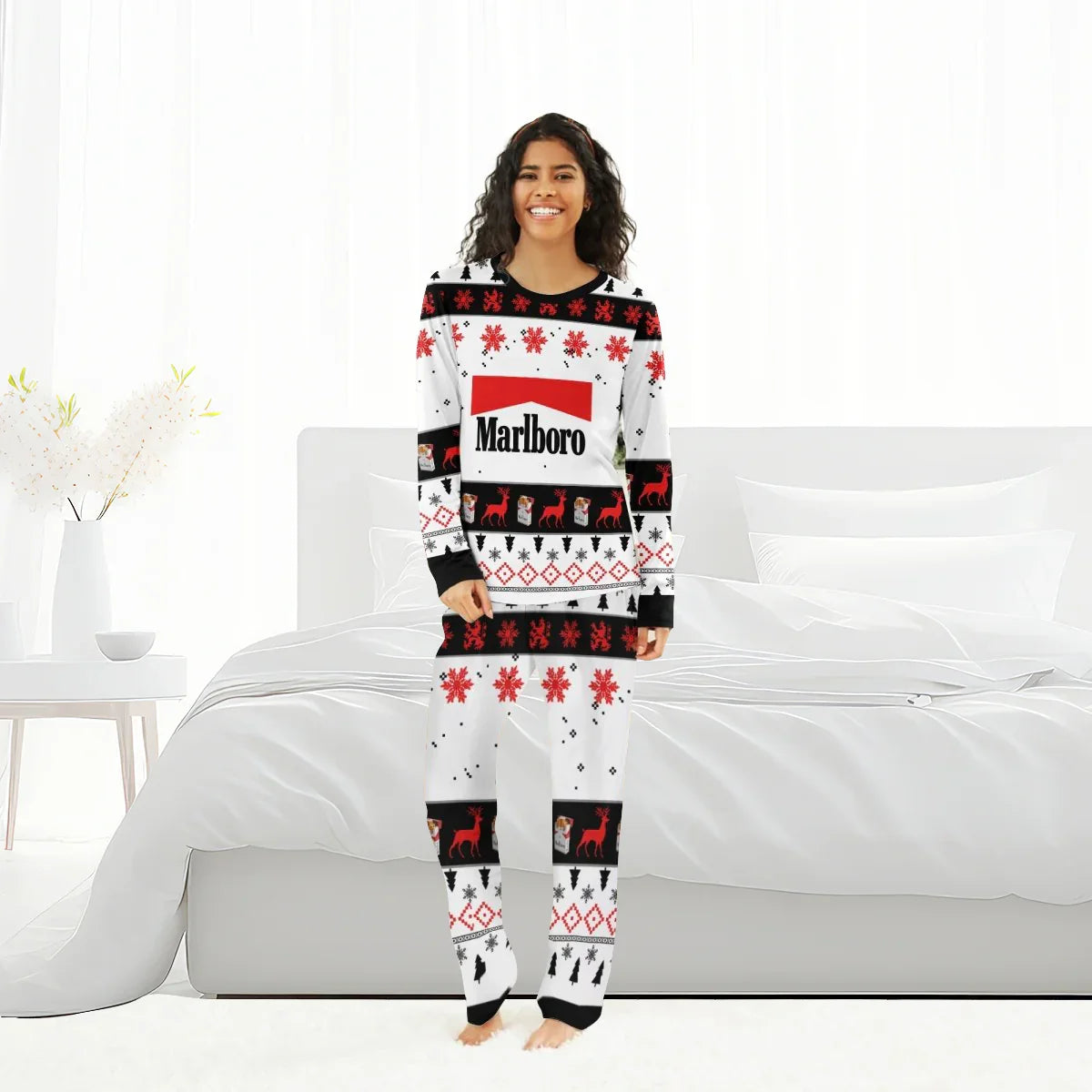 Smiling woman wearing Marlboro Christmas holiday pajama set with red, black, and white festive pattern in bright bedroom