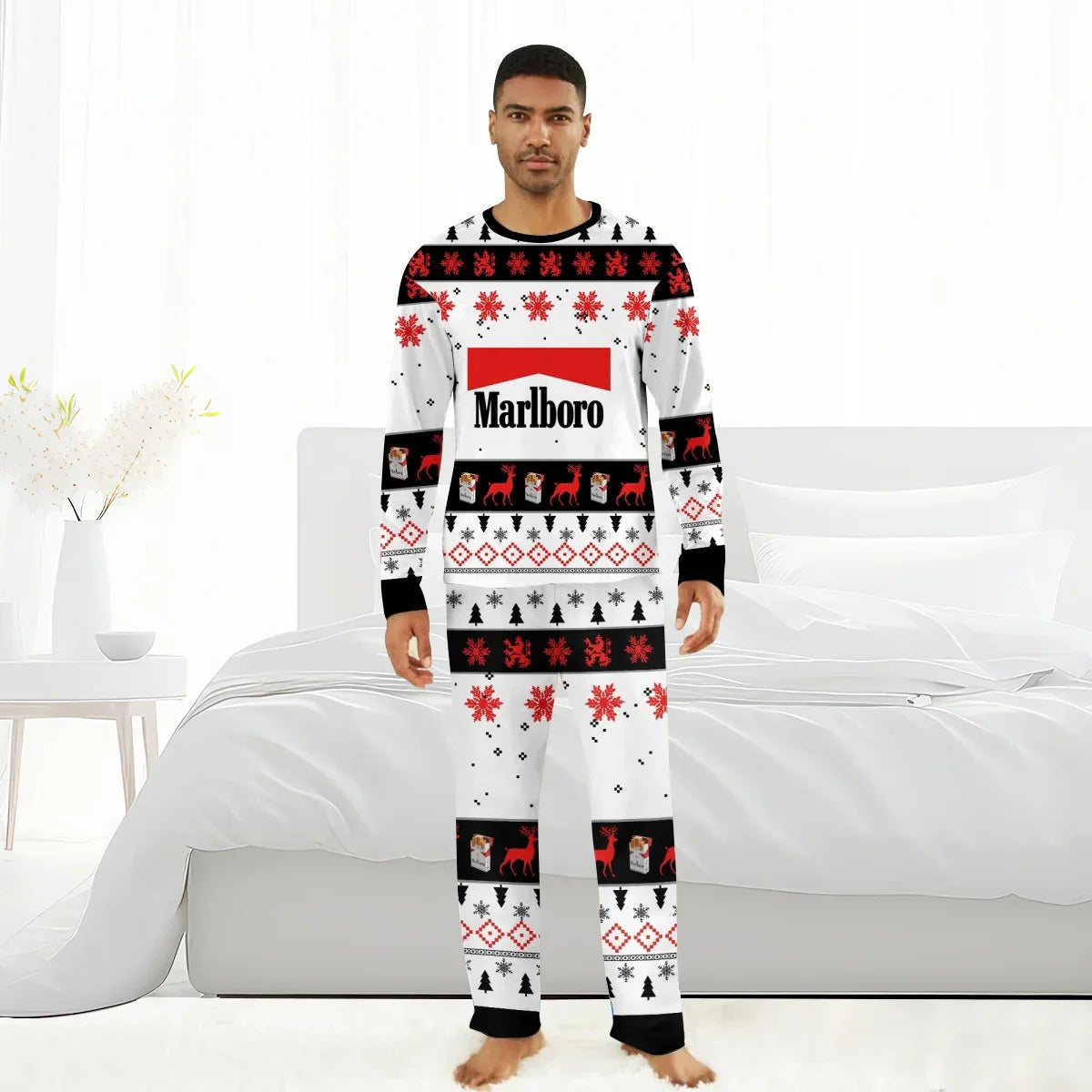 Man wearing Marlboro holiday pajamas with red snowflakes, reindeer, and black Christmas trees in white bedroom