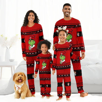 Happy family in matching red Grinch Christmas pajamas with Marlboro branding, smiling in bright bedroom