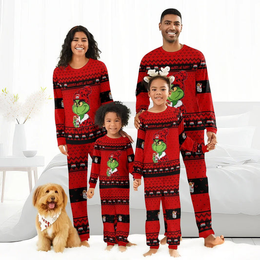 Happy family in matching red Grinch Christmas pajamas with Marlboro branding, smiling in bright bedroom