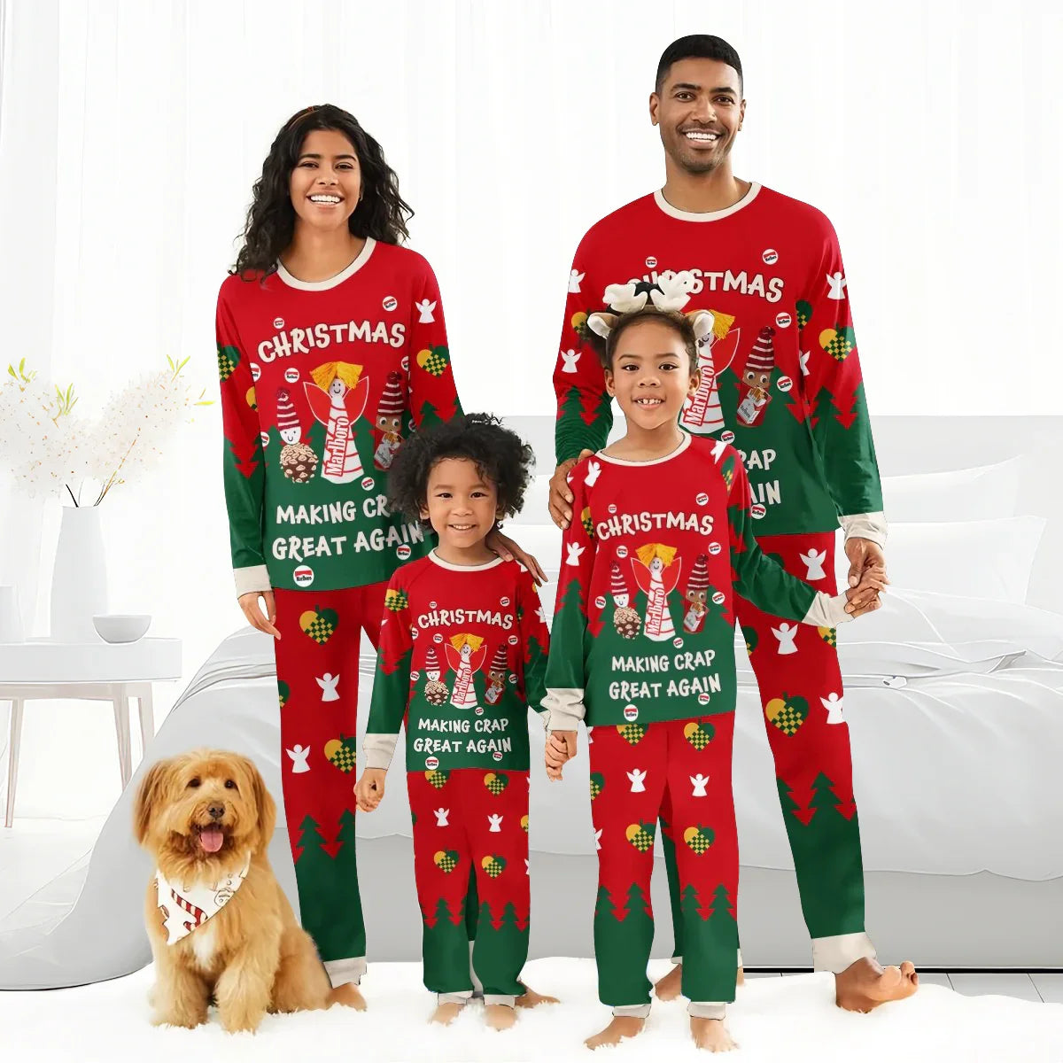 Family in matching red and green Christmas pajamas with festive designs, posing in a bright bedroom with a dog.