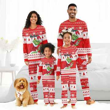Smiling family of four in matching red Marlboro Grinch Christmas pajamas with festive patterns and a dog wearing a holiday bandana