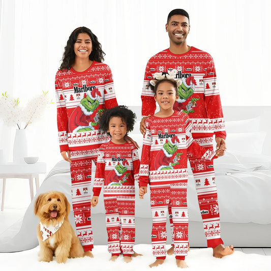 Smiling family of four in matching red Marlboro Grinch Christmas pajamas with festive patterns and a dog wearing a holiday bandana