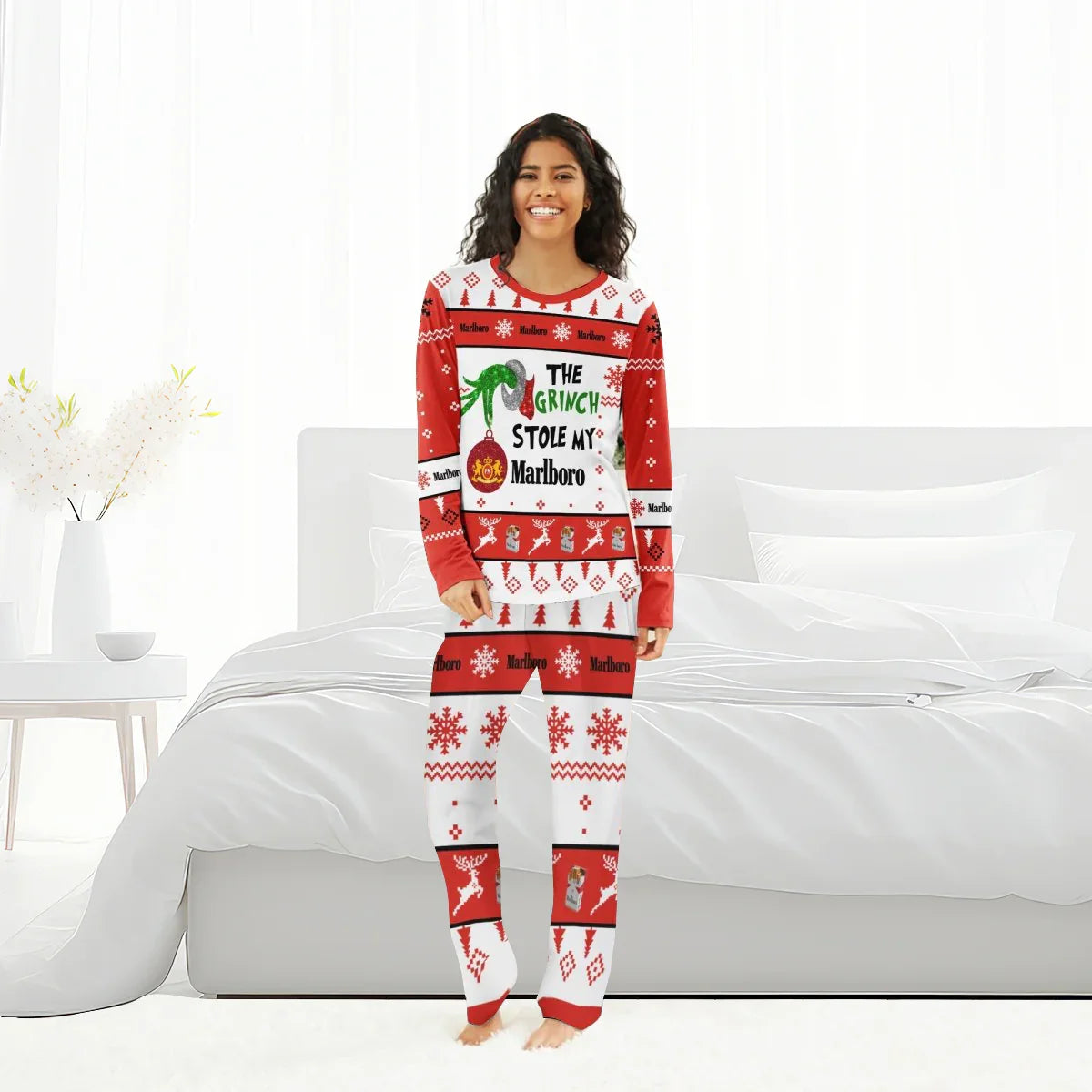 Smiling woman wearing red and white holiday pajamas with Grinch and Marlboro Christmas design