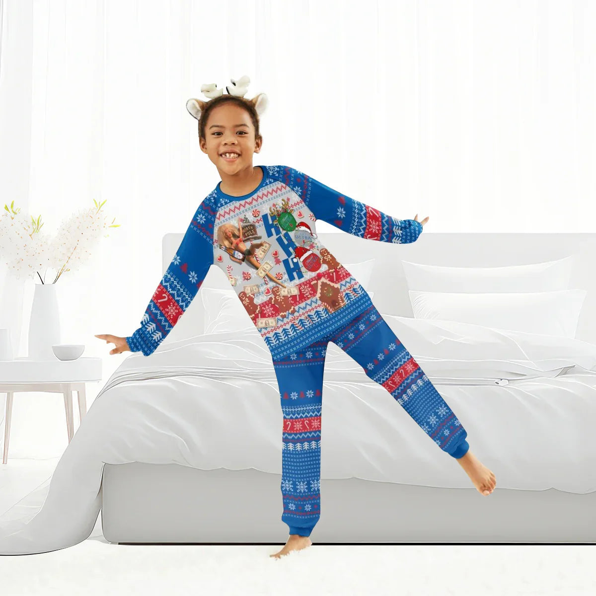 Girl wearing blue and red Christmas pajamas with holiday patterns and reindeer headband indoors