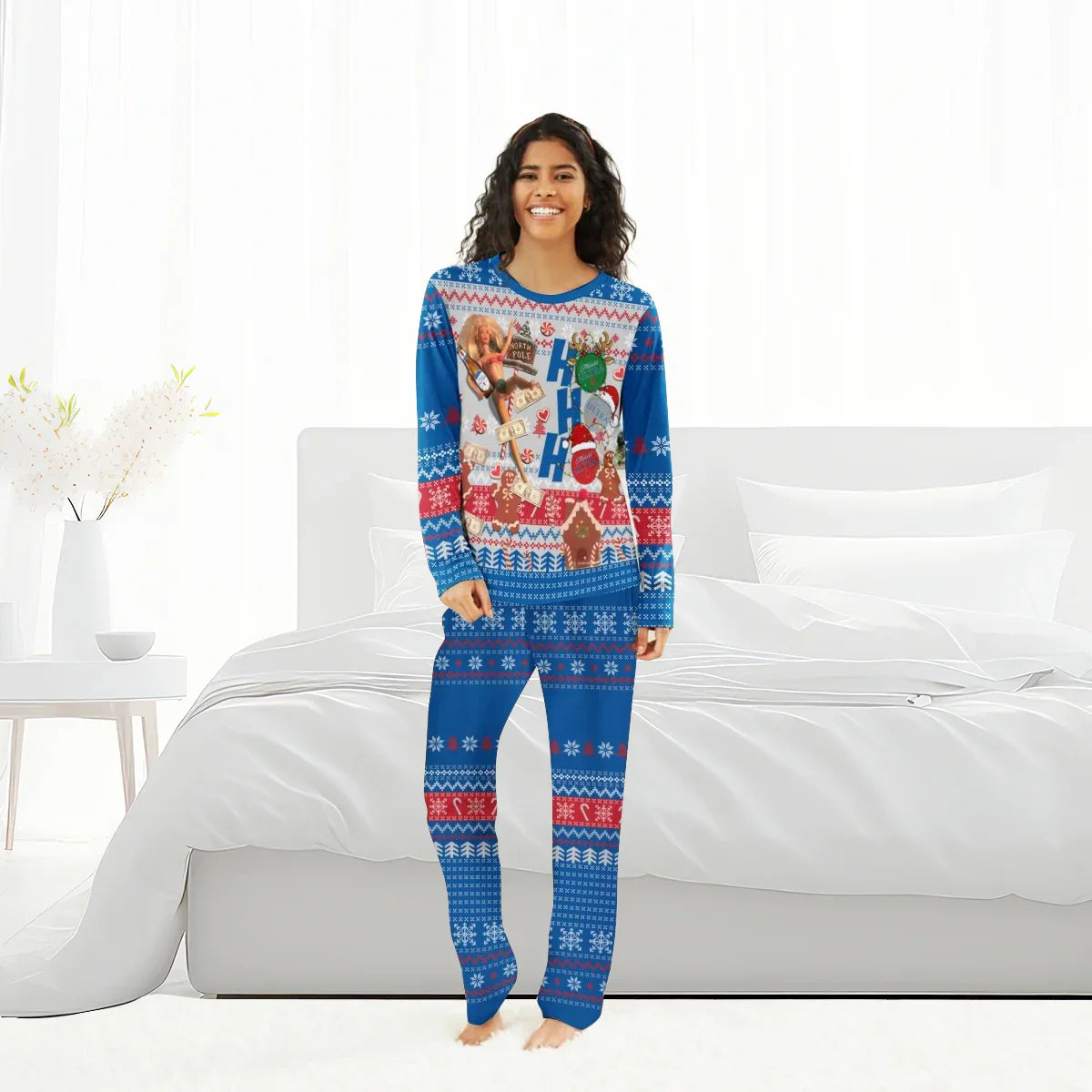 Smiling woman wearing blue festive holiday pajamas with Christmas and money print, standing in bright bedroom