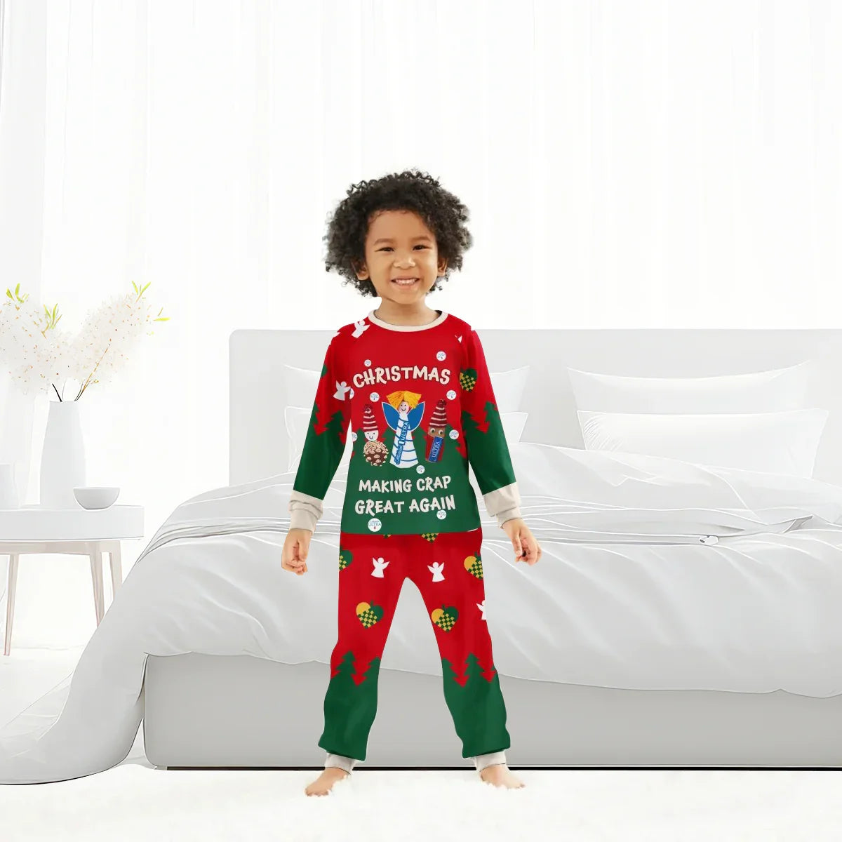 Smiling child in red and green Christmas pajamas with festive holiday patterns and text in bright bedroom
