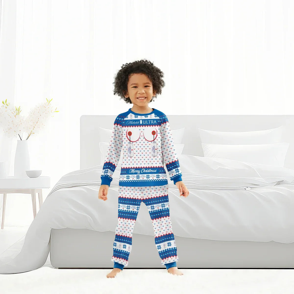 Child in Michelob Ultra Merry Christmas family pajamas set standing in a bright white bedroom