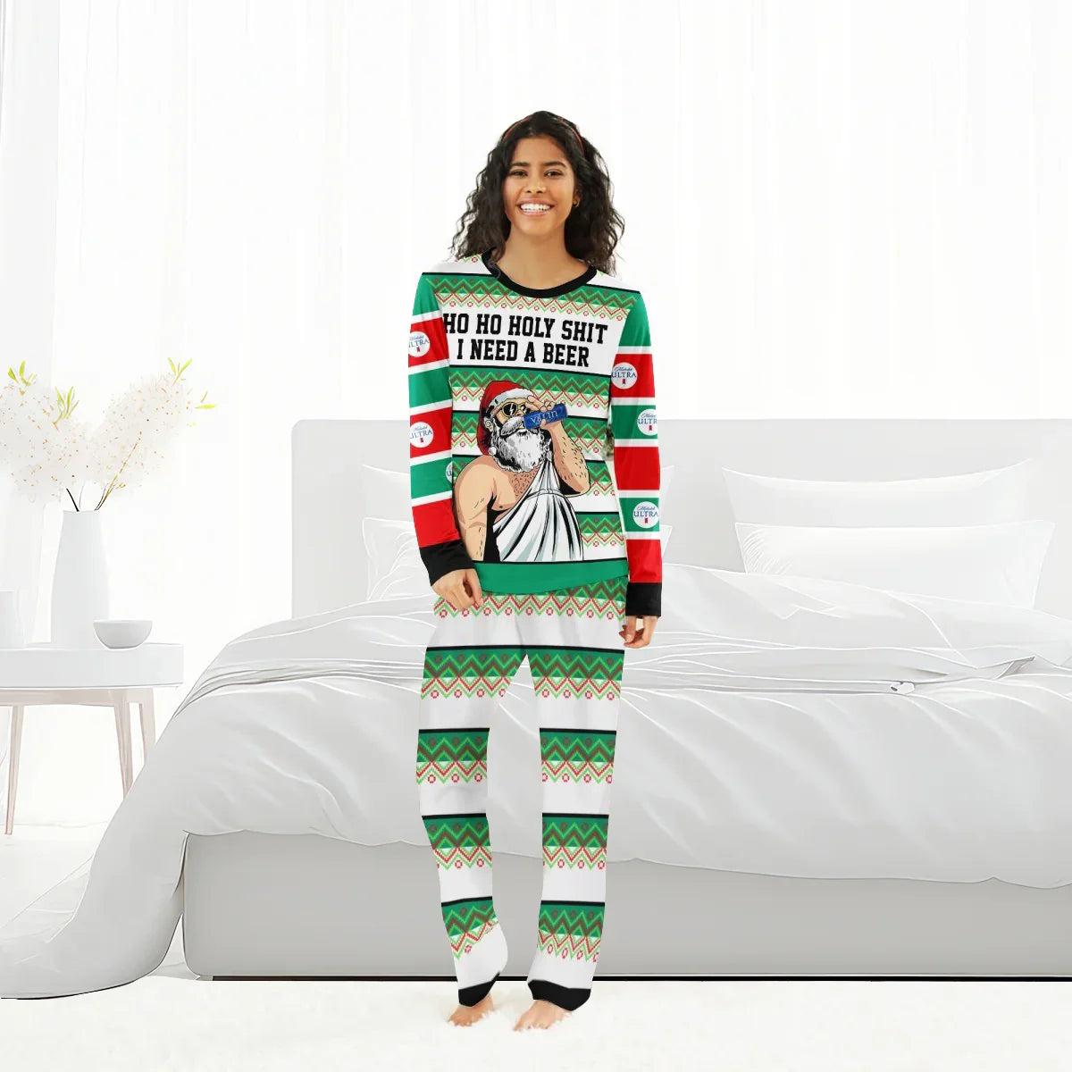 Smiling woman in green and red Christmas pajamas with Santa drinking beer and phrase I need a beer