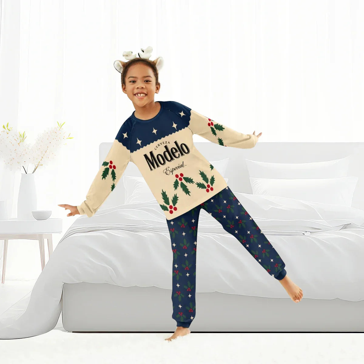 Child in festive Modelo Especial Christmas pajamas with holly and stars design indoors