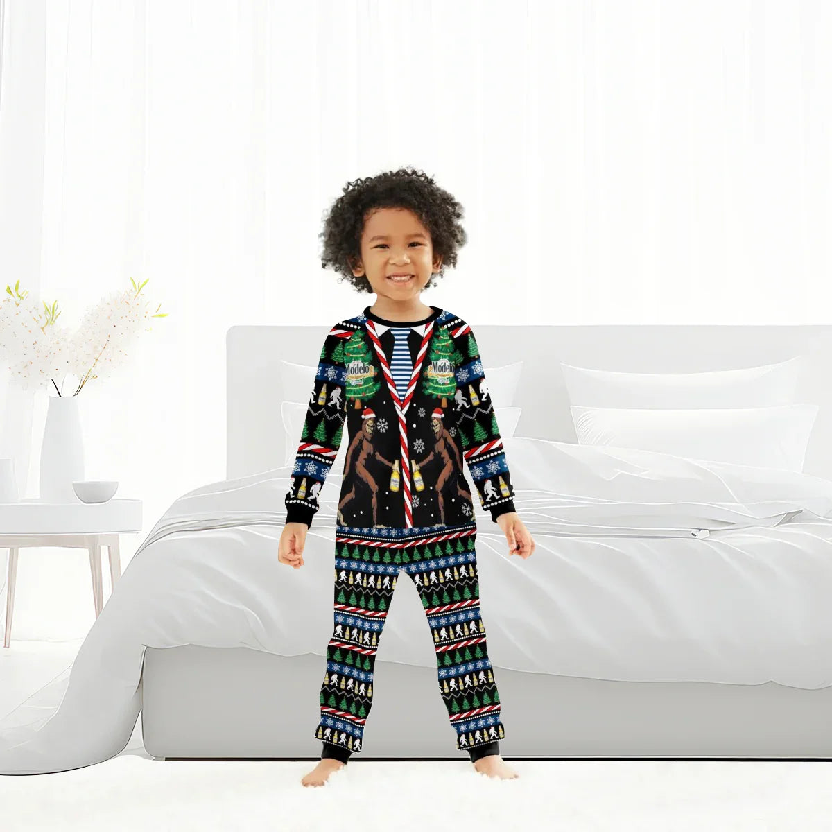 Smiling child in festive Bigfoot-themed Christmas Modelo pajamas standing in bright bedroom