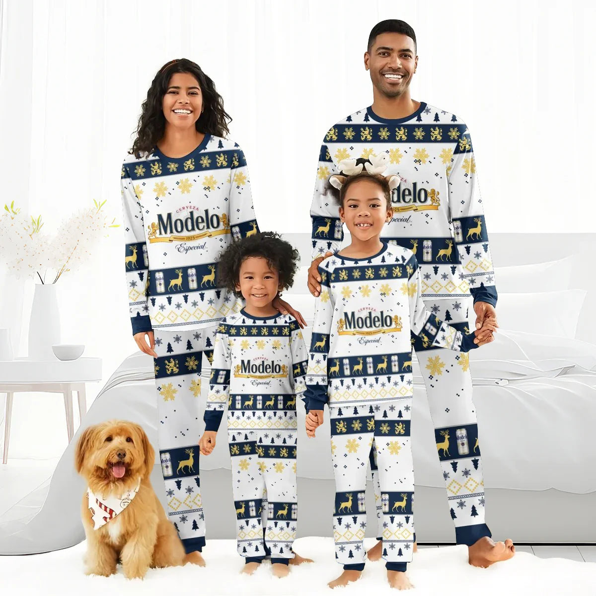 Smiling family of four and dog in matching Modelo holiday pajamas in white and navy bedroom