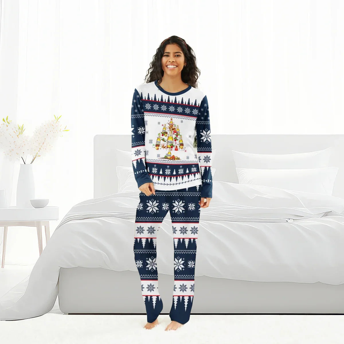 Smiling woman in Modelo Christmas tree family pajamas with snowflake and tree patterns in bright bedroom