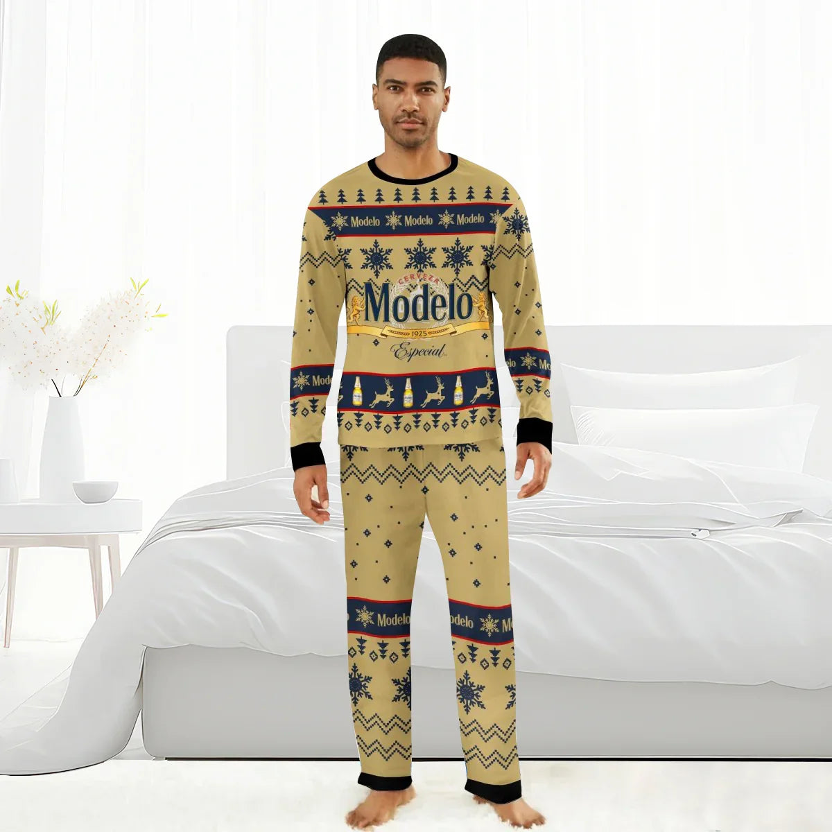 Man wearing Modelo Especial Christmas pajama set with beer bottle and snowflake patterns in a white bedroom
