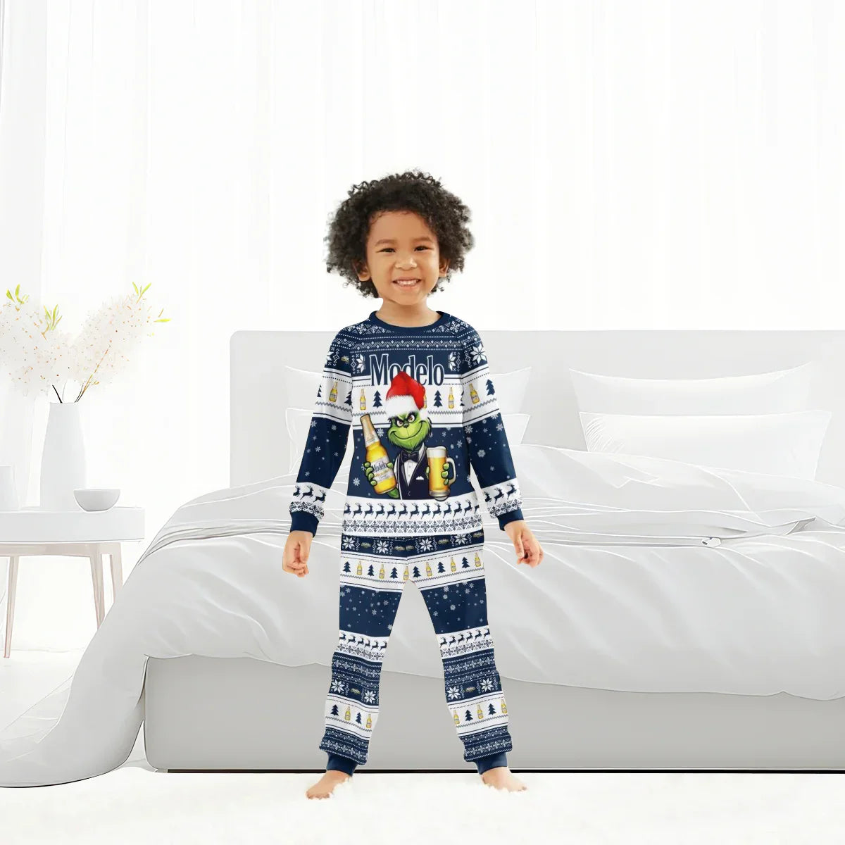 Smiling child in blue Modelo Grinch Christmas family pajamas standing in modern white bedroom