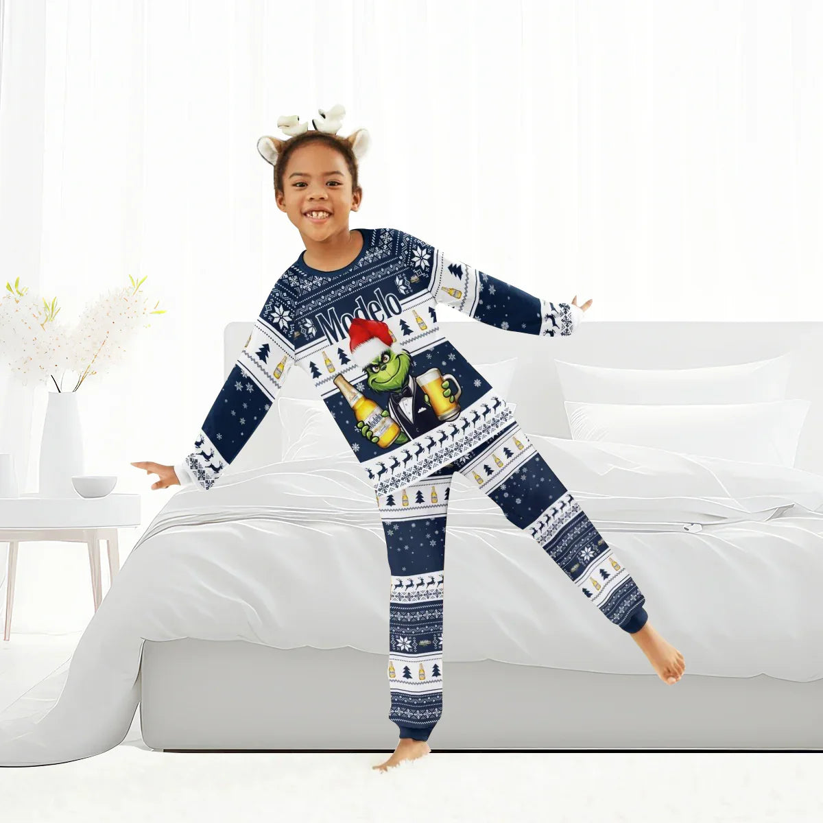 Child in bedroom wearing Modelo Grinch Christmas family pajamas with navy blue and white holiday patterns