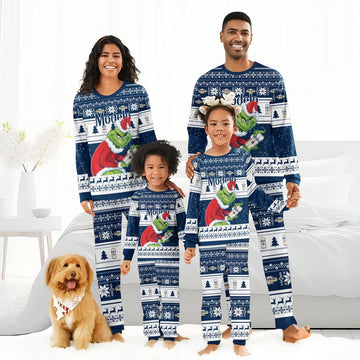 Smiling family wearing matching blue Modelo Santa Grinch holiday pajamas with Christmas patterns and dog with festive bandana