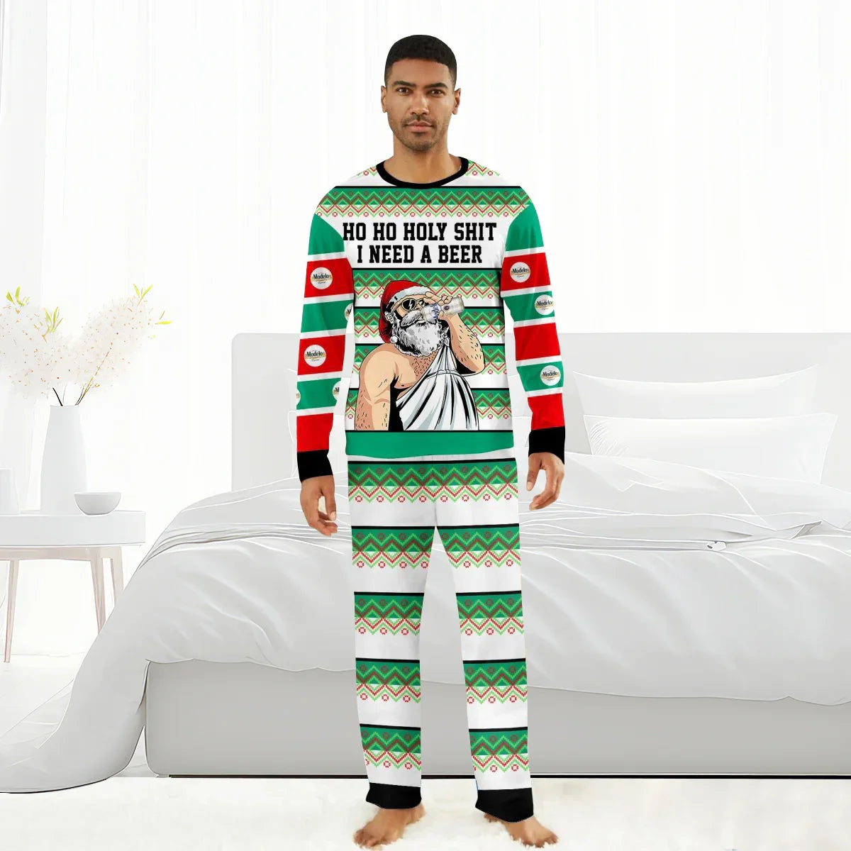 Man wearing green and red Christmas pajamas with Santa drinking beer and text 'HO HO HOLY SHIT I NEED A BEER'