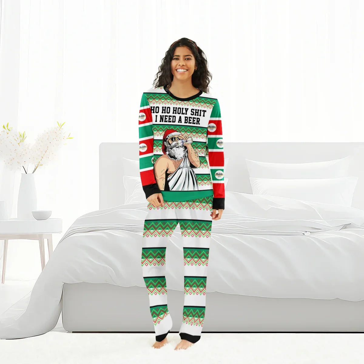 Smiling woman wearing green and red Christmas pajamas with Santa drinking beer and text 'HO HO HOLY SHIT I NEED A BEER'