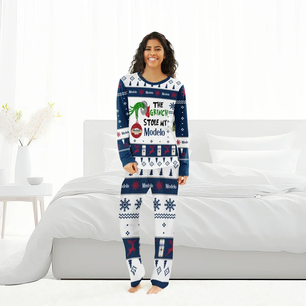 Woman wearing festive Modelo The Grinch Stole My Modelo Christmas pajama set in bedroom
