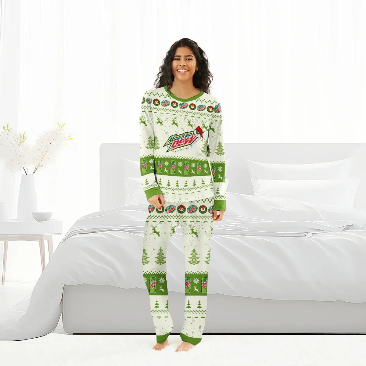 Smiling woman wearing Mountain Dew Christmas reindeer family pajamas with green and white festive patterns in bright bedroom