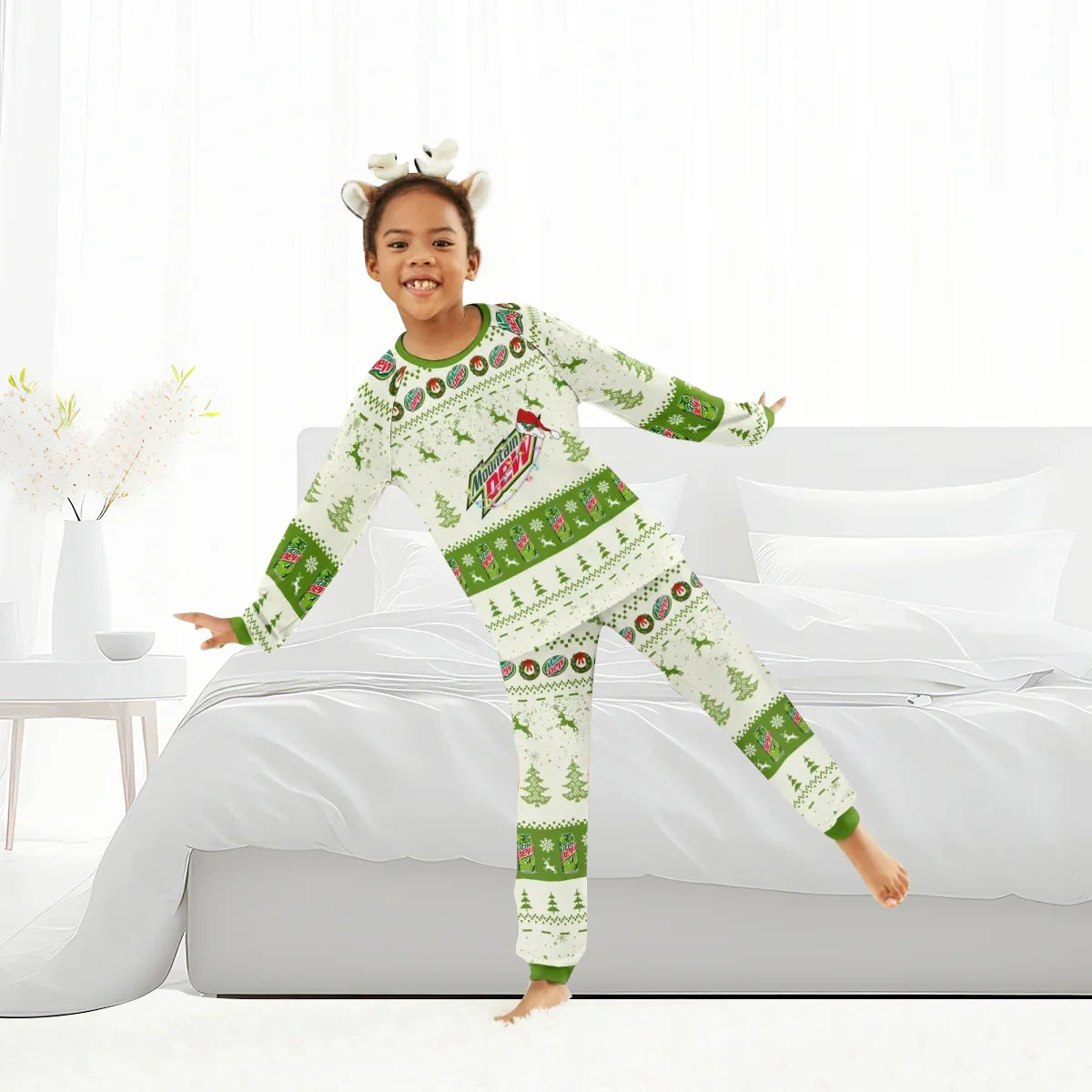 Child wearing Mountain Dew Christmas reindeer family pajamas with antler headband in bright bedroom