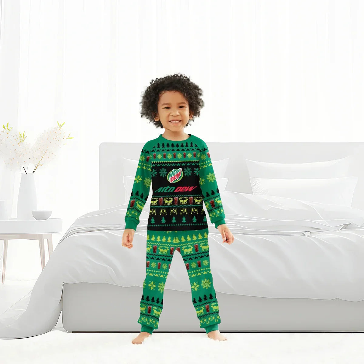 Child standing in bright bedroom wearing green Mountain Dew Christmas pajamas with holiday patterns