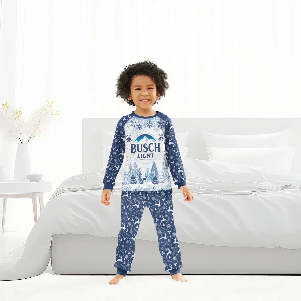 Smiling child wearing blue Busch Light Christmas winter pajamas with snowflake and reindeer patterns