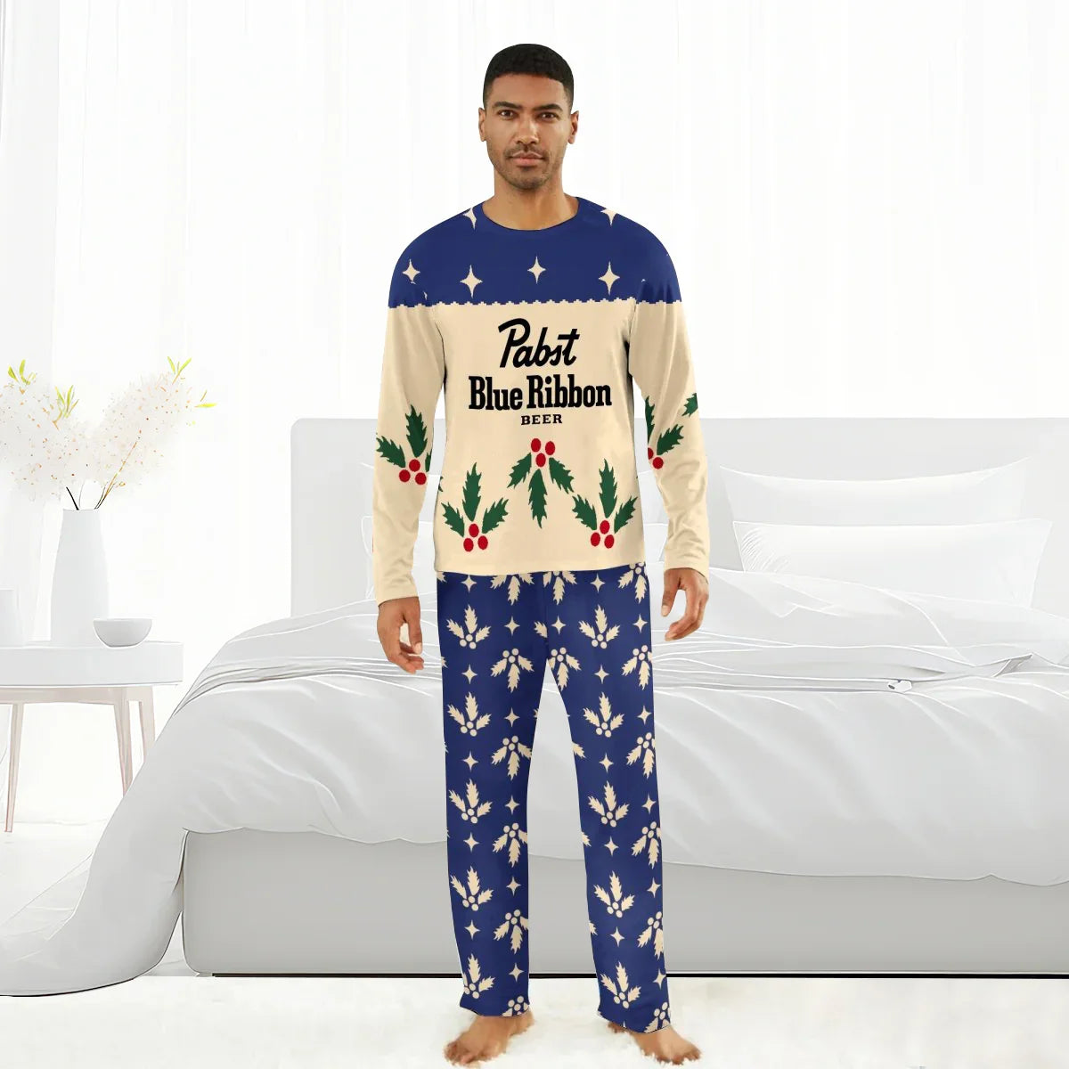 Man wearing Pabst Blue Ribbon Christmas-themed pajamas with holly and star patterns in a bright bedroom