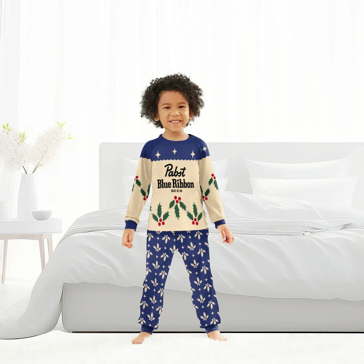 Smiling child in Pabst Blue Ribbon festive Christmas cherry pajama set in bright bedroom