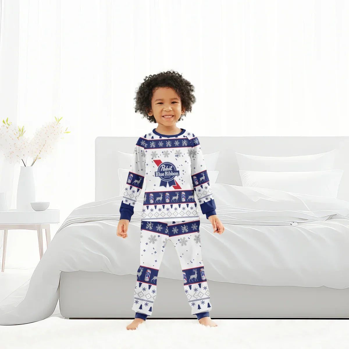 Smiling child in Pabst Blue Ribbon Christmas pajamas standing barefoot in a bright modern bedroom