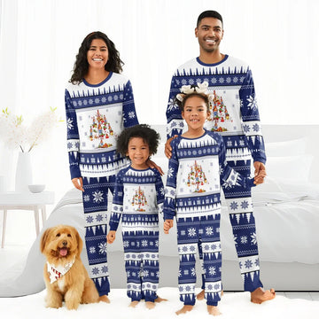 Happy family of four and dog wearing matching blue and white Christmas Pabst Blue Ribbon pajamas in bright bedroom