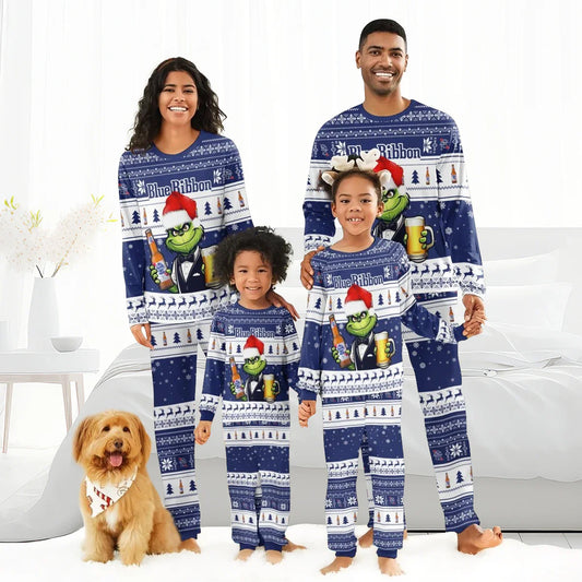 Smiling family of four wearing matching blue Pabst Blue Ribbon holiday pajamas with the Grinch and festive patterns, with a dog wearing a holiday bandana