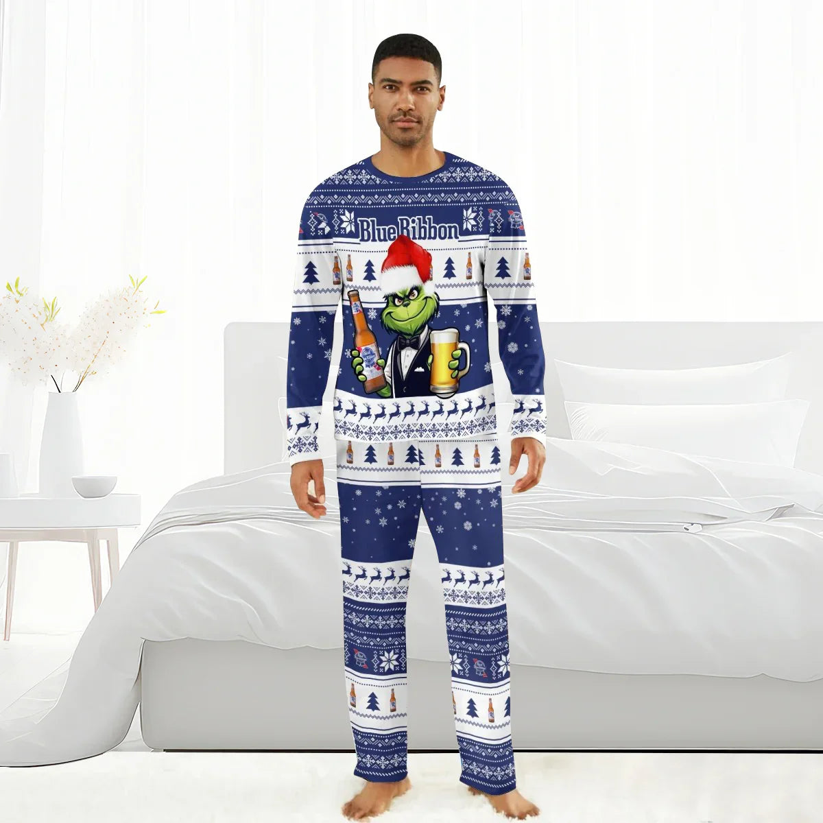 Man wearing blue and white Pabst Blue Ribbon holiday pajamas with Grinch holding beer bottle and glass