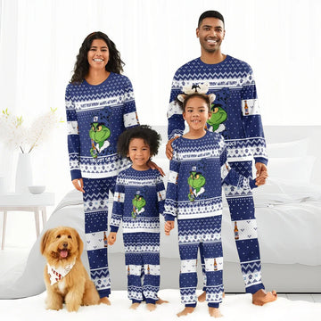 Smiling family in matching blue Grinch and Pabst Blue Ribbon holiday pajamas with dog in festive bandana
