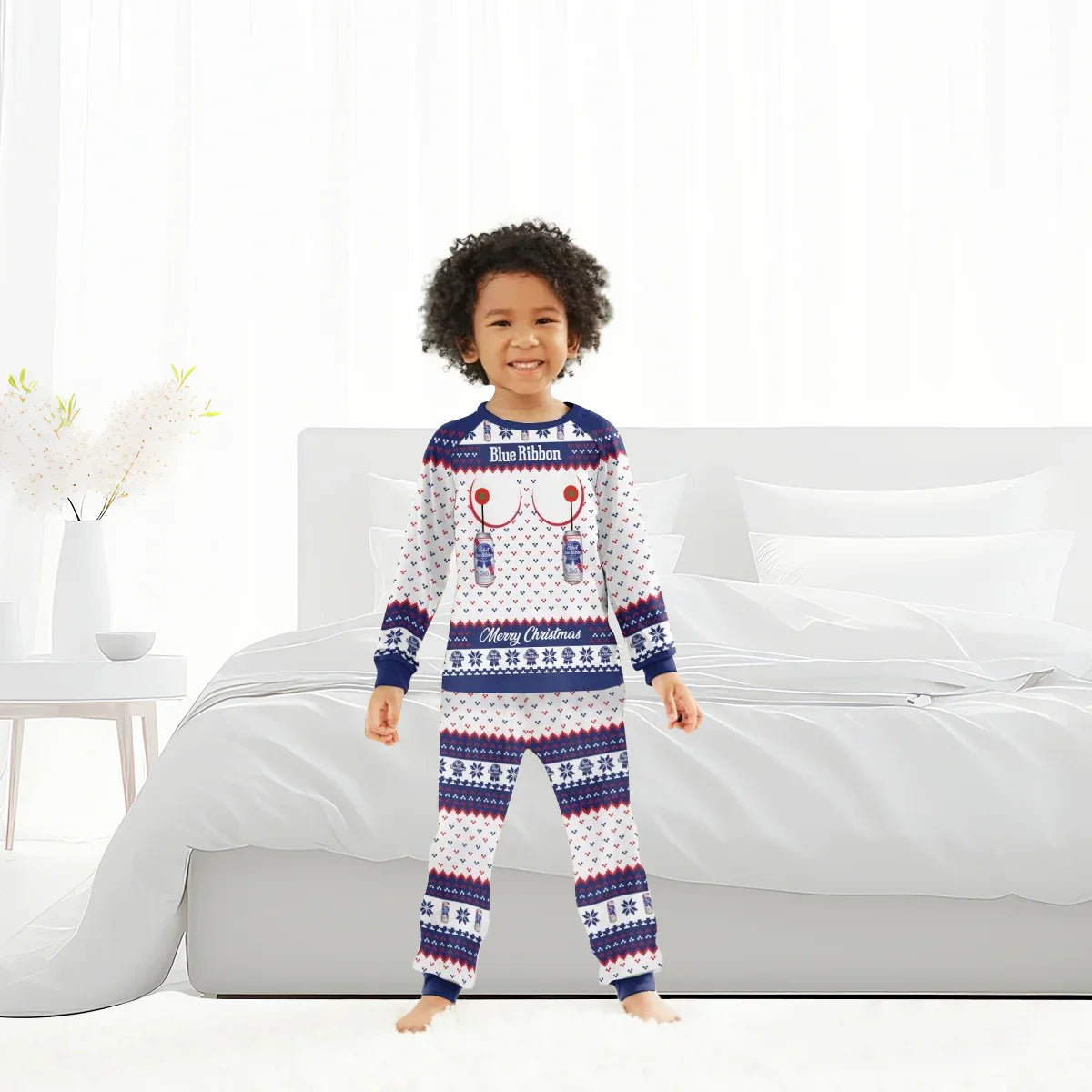 Child smiling in Blue Ribbon Merry Christmas family pajama set in bright bedroom