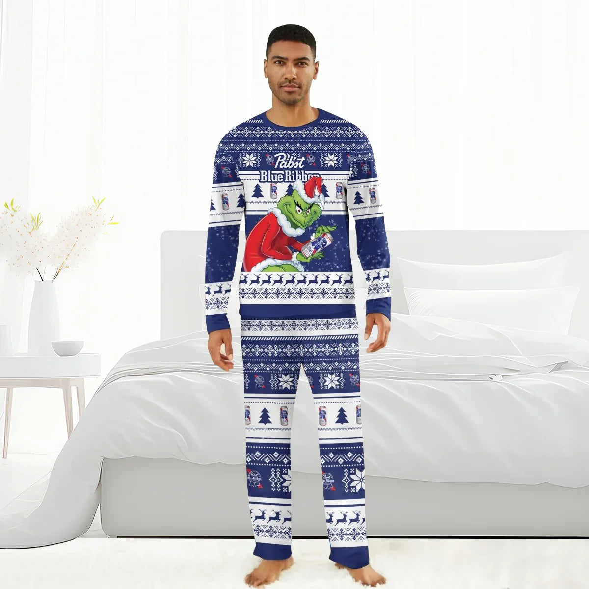 Man wearing Pabst Blue Ribbon holiday pajamas featuring the Grinch in Santa outfit holding a beer can
