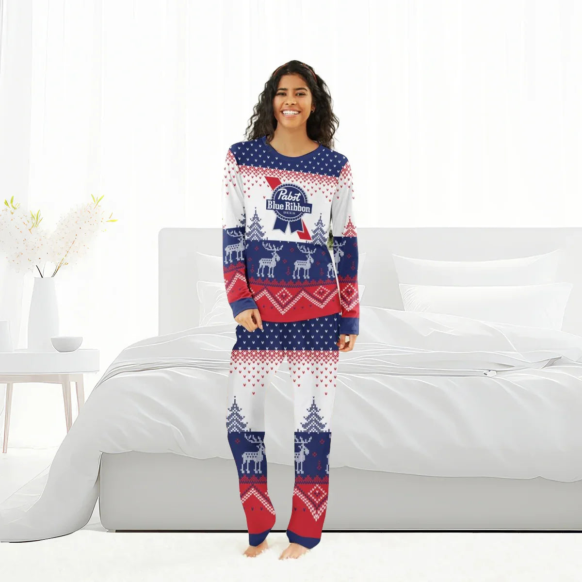 Woman wearing Pabst Blue Ribbon winter reindeer family pajamas in red, white, and blue in a bright bedroom
