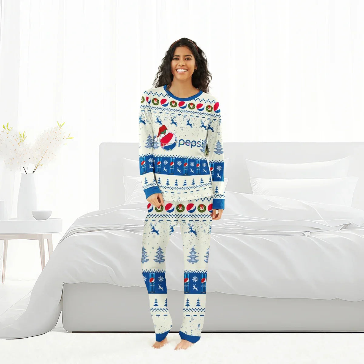 Smiling woman wearing Pepsi Christmas reindeer family pajamas in white and blue in a bright bedroom