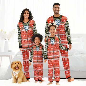 Happy family in matching Busch Latte camo Christmas pajamas with red holiday patterns and pet dog