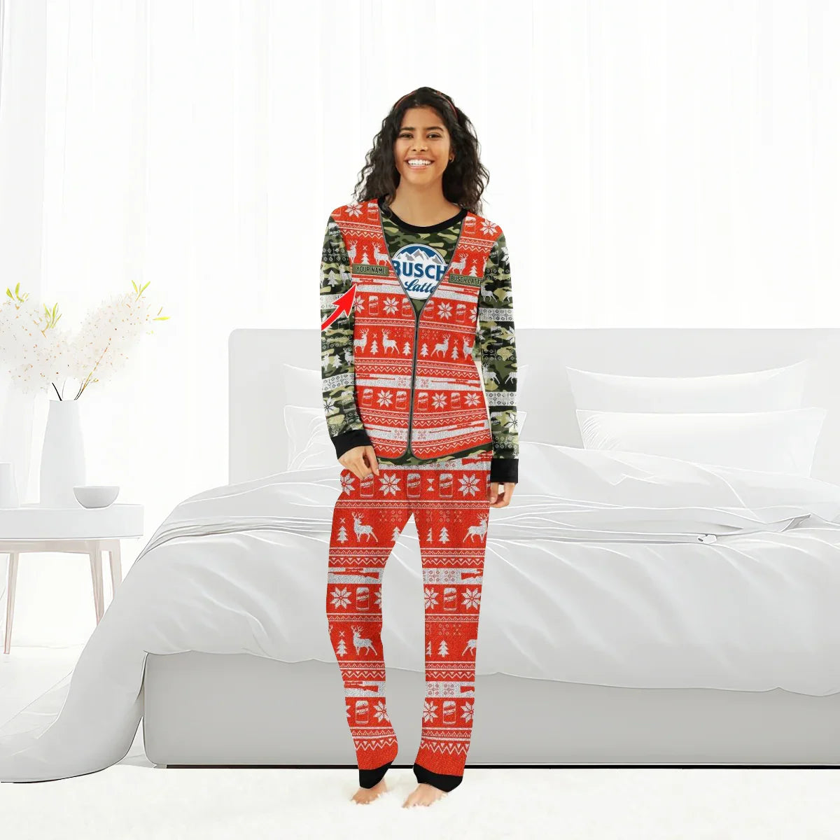 Woman wearing personalized camo and red Christmas pajamas with reindeer and snowflake patterns in bright bedroom