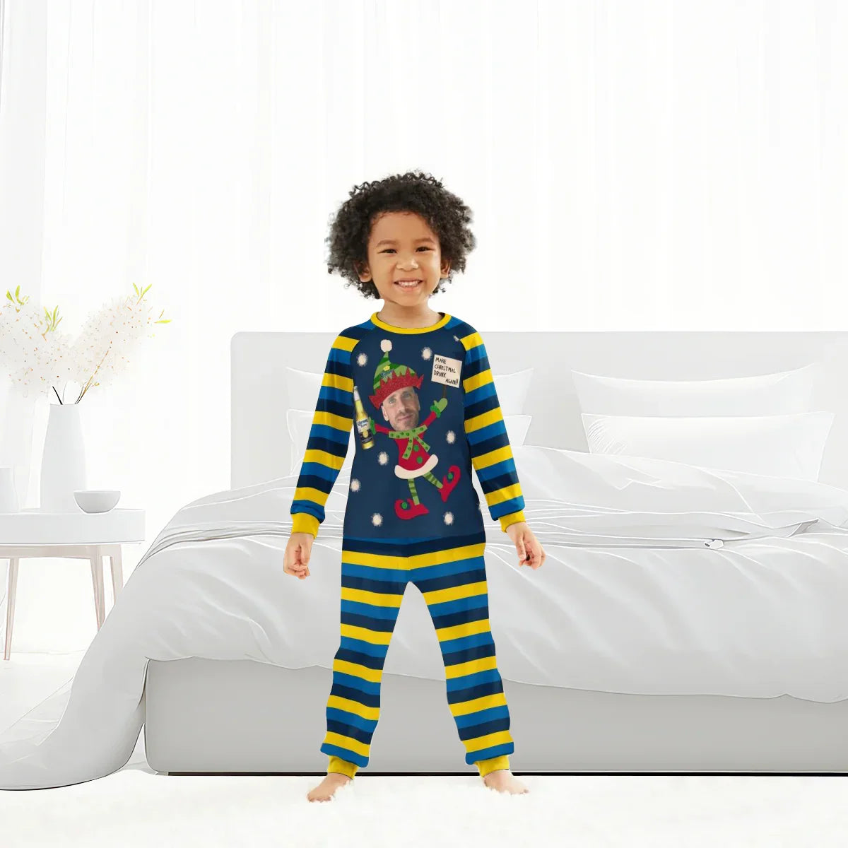 Child wearing blue and yellow striped personalized Christmas pajamas with elf design and custom face