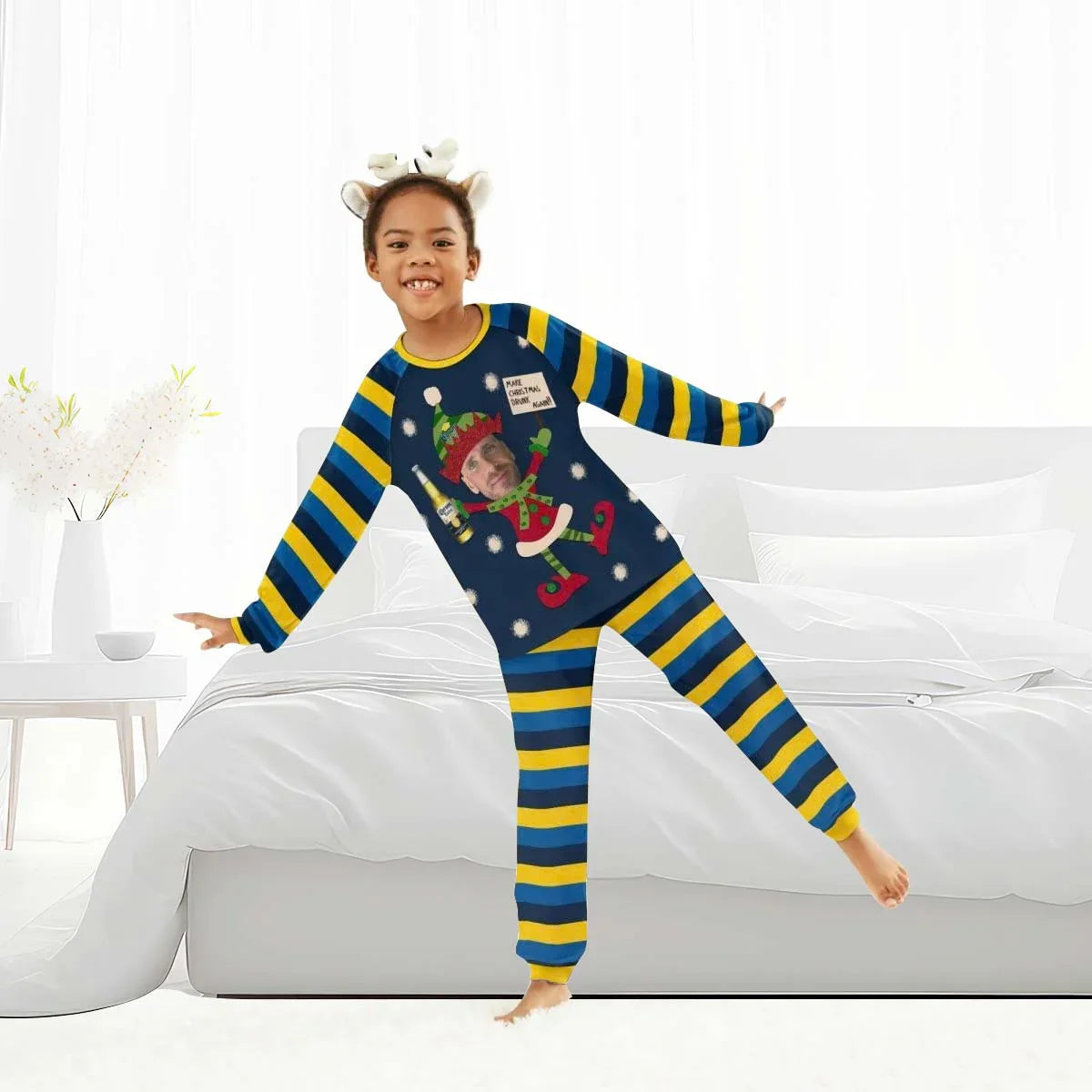 Child wearing blue and yellow striped Christmas pajamas with a personalized Corona Extra elf design, standing playfully