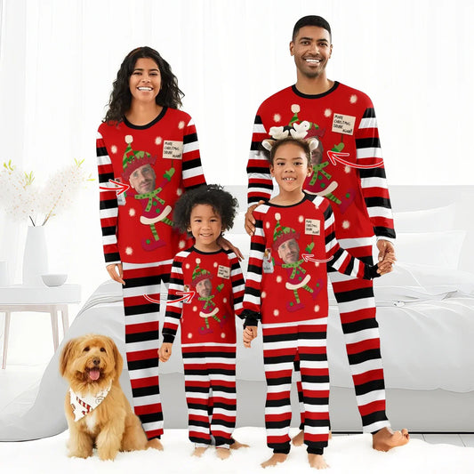 Family of four in matching red striped Christmas pajamas with personalized elf designs and a dog in holiday bandana