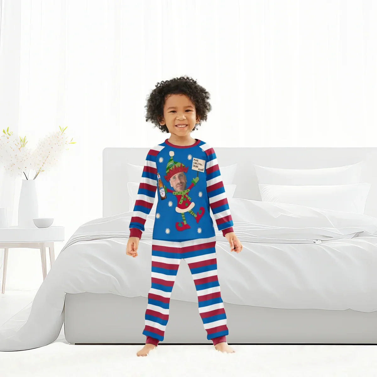 Child wearing blue and red striped personalized Christmas pajamas with holiday elf design and photo print